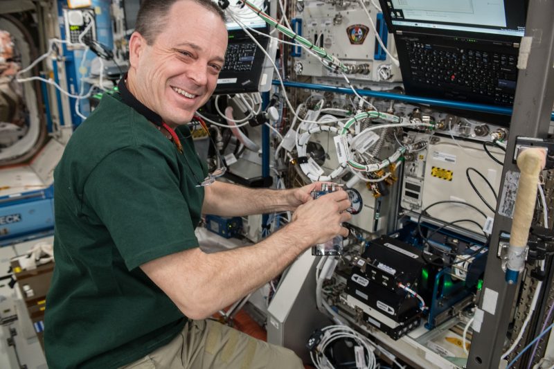 Caption: NASA astronaut works with Redwire’s Bone Densitometer on the ISS. (Credit: NASA)
